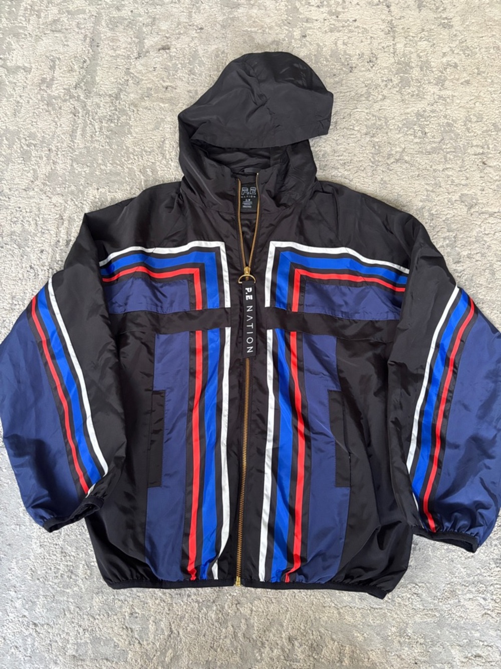 P.E Nation Black Hooded Windbreaker with Blue, Red & White Stripe Panels